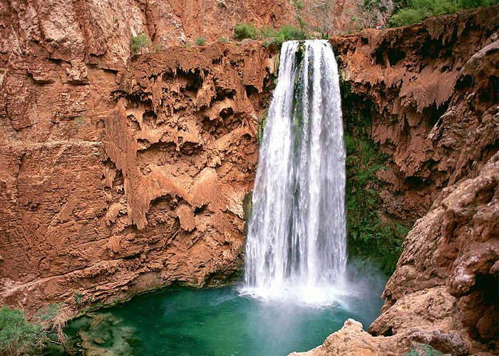 Havasu Falls is a waterfall of Havasu Creek, located in the Grand Canyon, Arizona, United States. It is within Havasupai tribal lands.