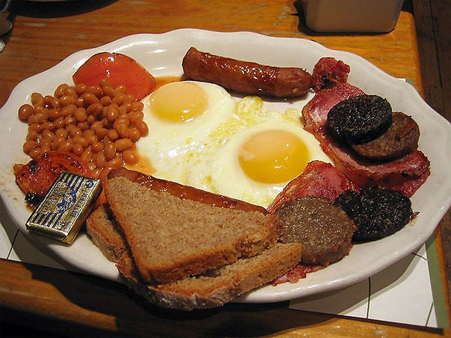 England: A full English breakfast consists of: bacon, eggs, grilled tomato, mushrooms, bread, black pudding and baked beans. And of course a cup of tea.