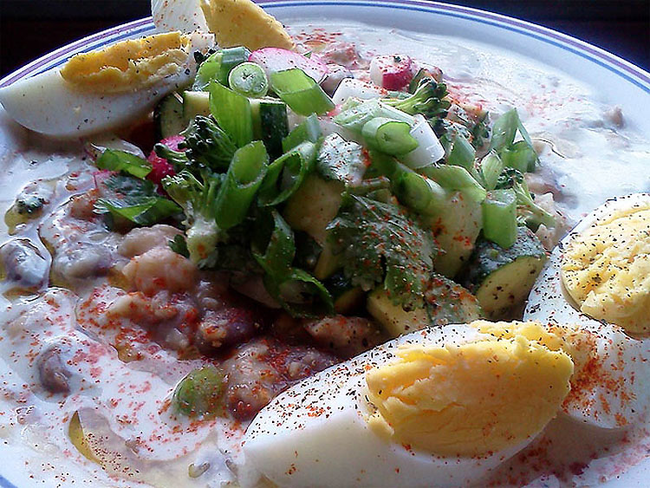 Egypt: This dish is called Foul Madamas. It's made up of fava beans, chickpeas, garlic, and lemon. Plus some hard boiled eggs, tahini sauce, and veggies.