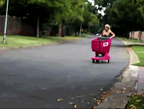 gifs - woman tries to jump into a shopping cart and falls