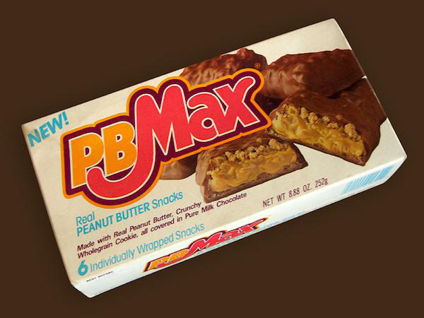PB Max
Crumbled cookie, a dollop of peanut butter, and a milk chocolate coating made these things to die for. As a hybrid between a snack and a candy bar, it makes sense why they didn’t last. It’s a damn shame though.