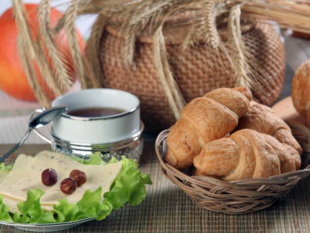 PORTUGAL: A standard breakfast includes stuffed croissants or bread with jam or cheese, eaten with coffee.