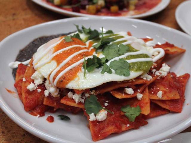 MEXICO: Mexican comfort food at its finest, chilaquiles are totopos (similar to tortilla chips) submerged in a spicy sauce with a fried egg and various toppings such as avocado.