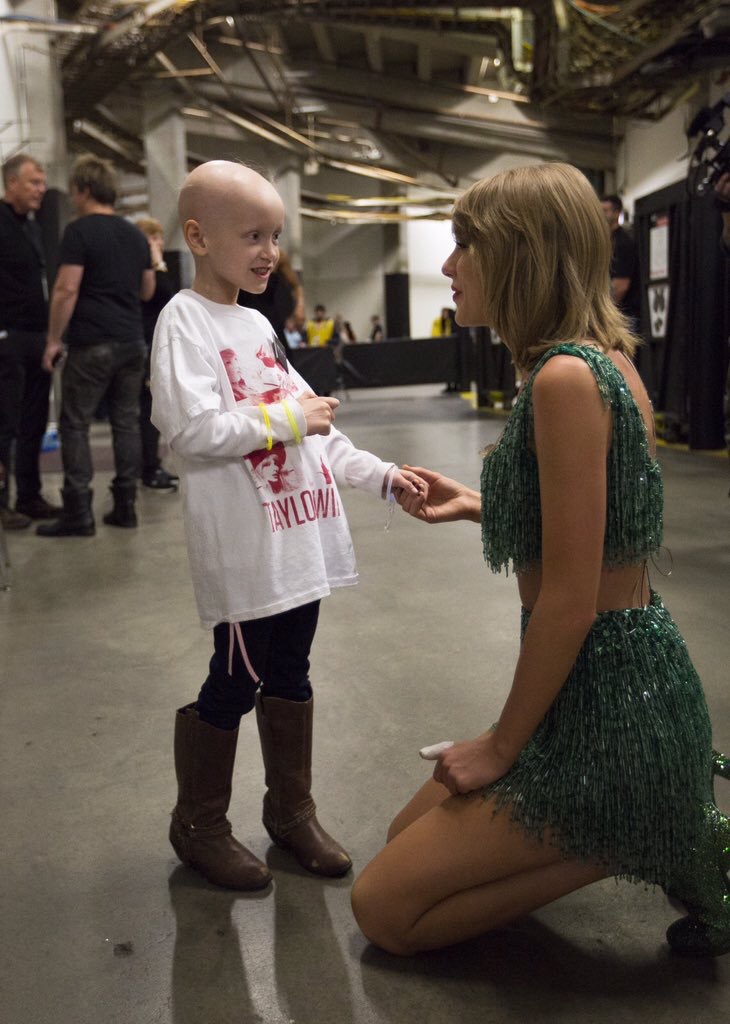 Taylor Swift meeting a young fan backstage.
