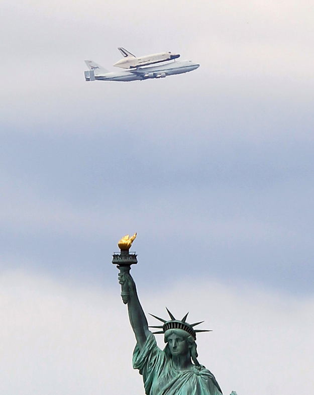 The Space Shuttle Enterprise flying over New York.