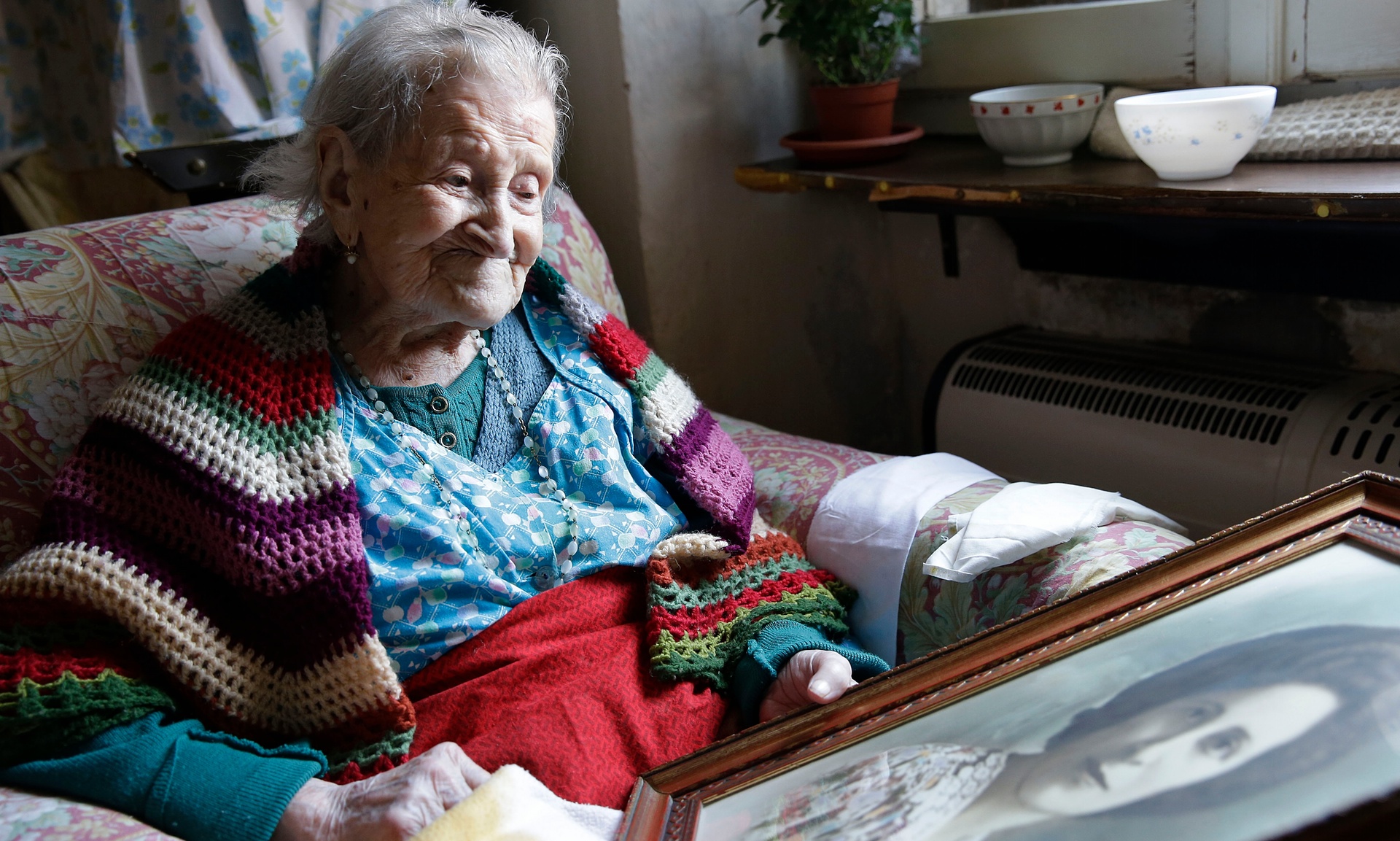 116 y/o Emma Morano looking at a much younger portrait of herself