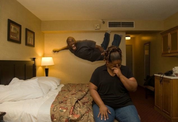black guy jumps on bed