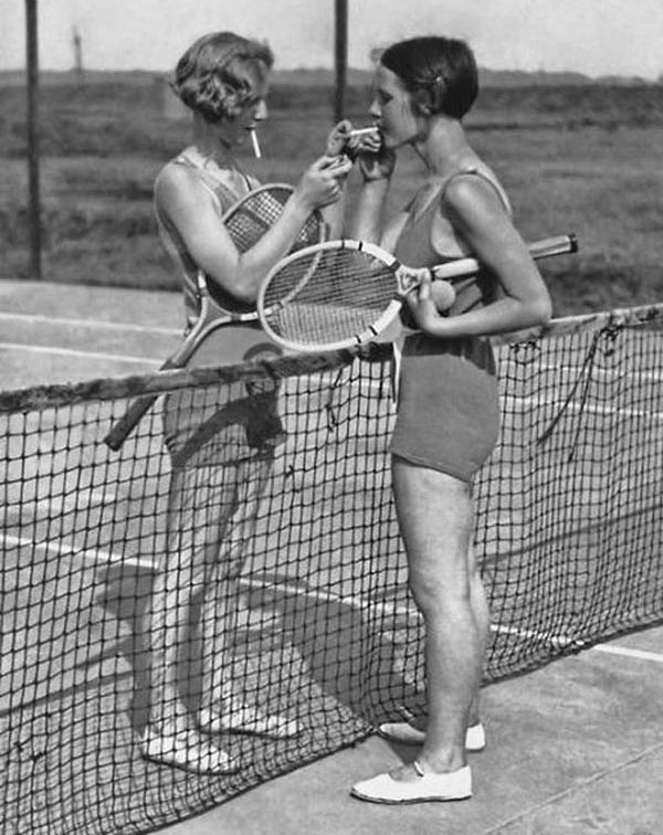random old school black and white tennis picture girls lighting each other cigarettes