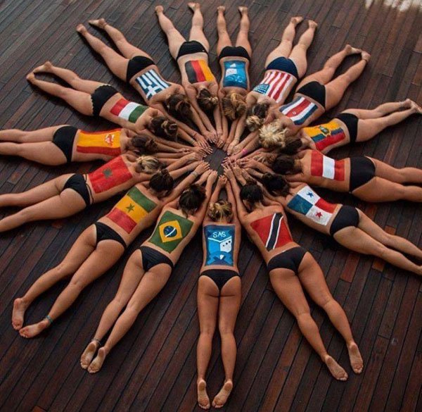 girls in swimsuit bottoms making a circle representing their country