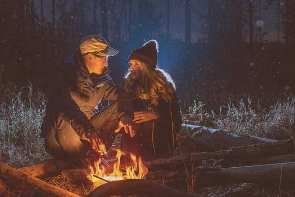 two people around a campfire