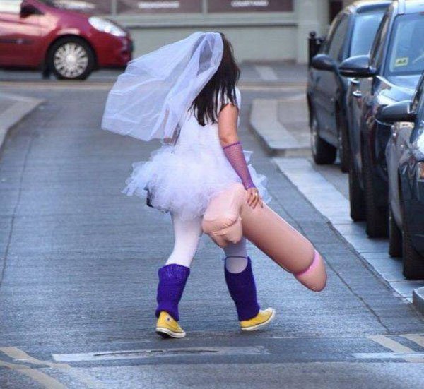 Woman dressed as a bride with a massive inflatable toy