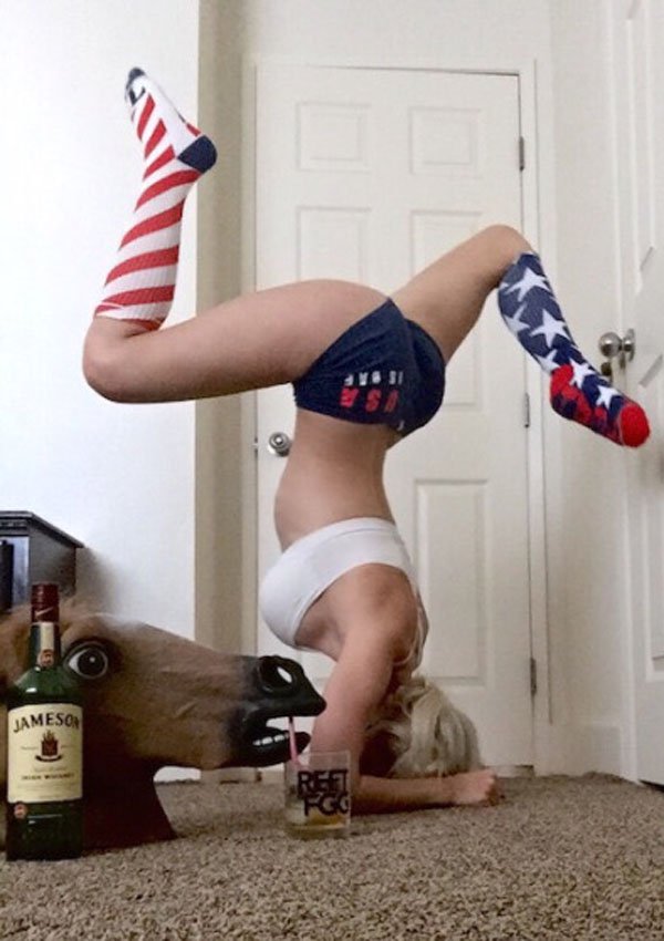 Girl who owns horse head mask doing a headstand in all americana gear