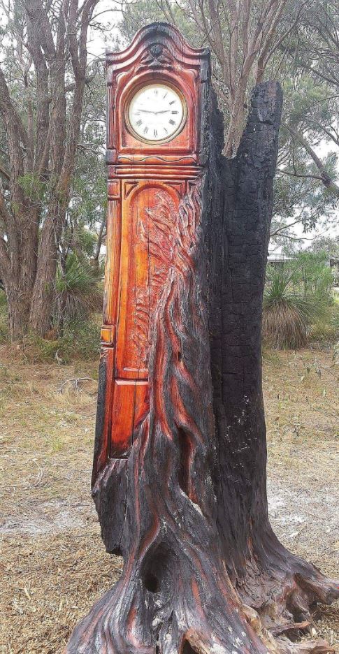 Grandfather clock carved into an old tree