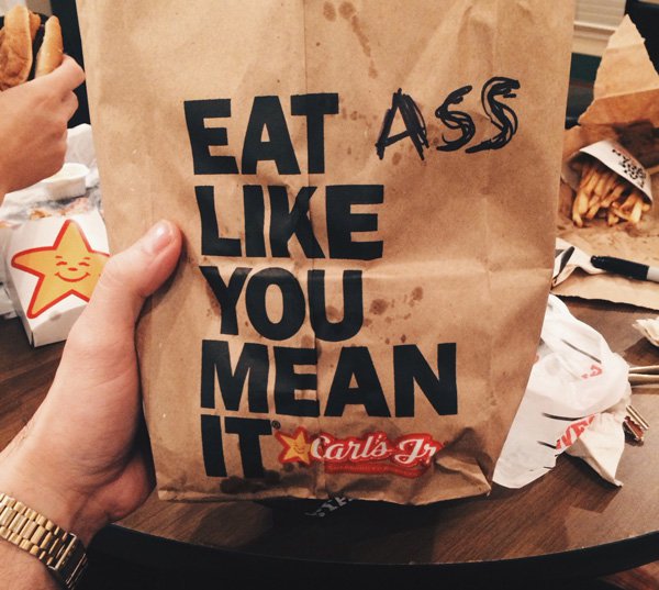 Carl's Jr bag that has 1 word added to it making it hilariously inappropriate.