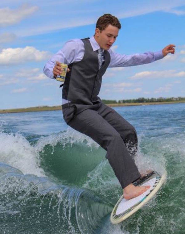 Man in a suit surfing