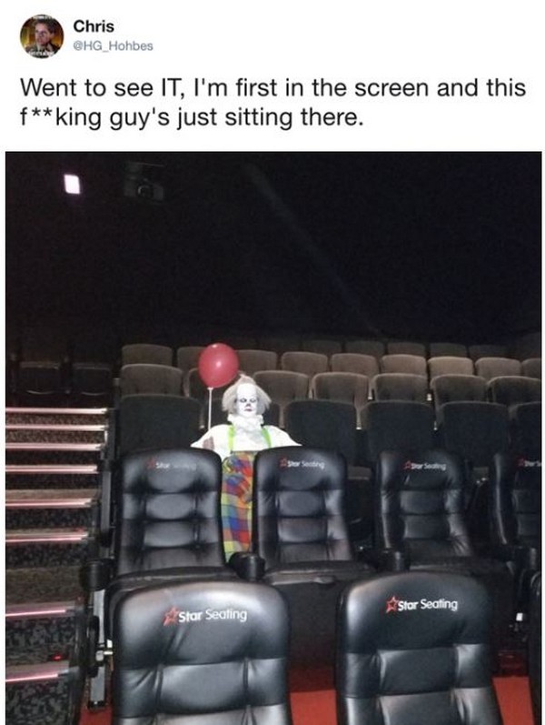 Creepy clown at the movie IT just sitting there with a red balloon