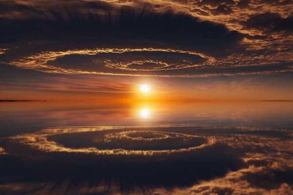 amazing sunset over cloud spirals and their reflection