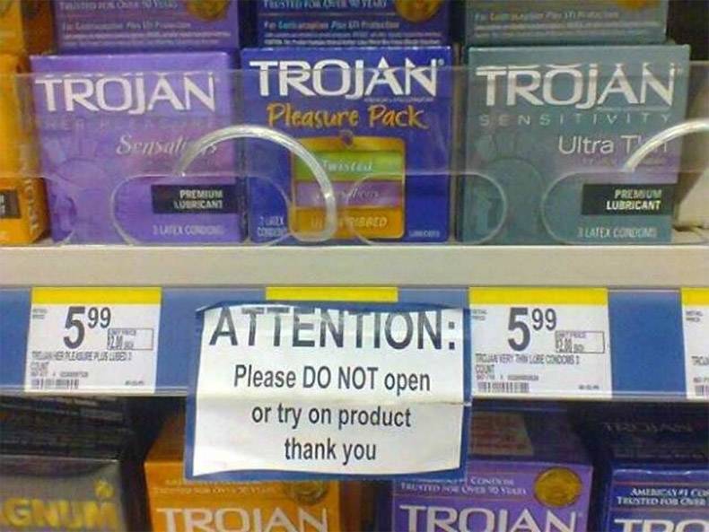Funny picture of notice at the pharmacy explaining to customers not to open or try on the products around the condoms