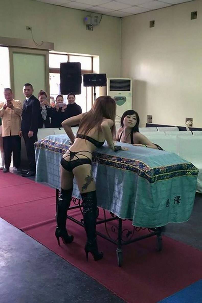 funny picture of stripers at a funeral entertaining the casket