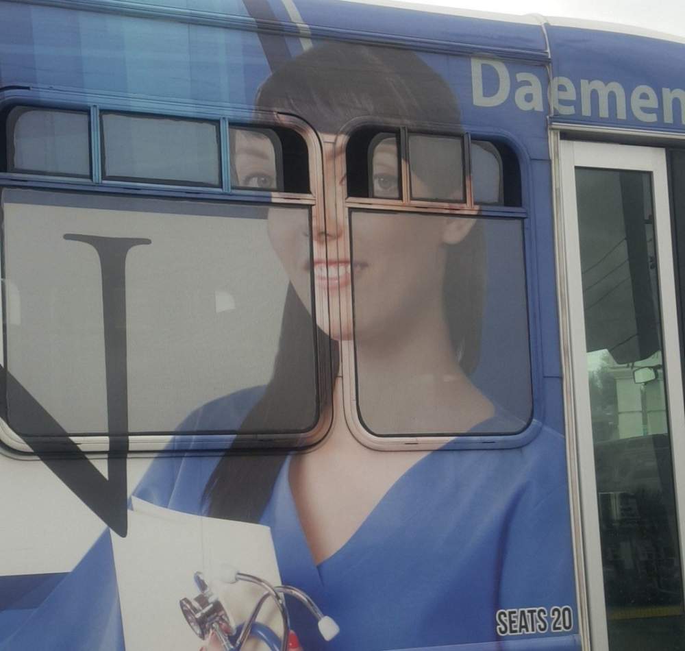girl on bus advertisement with windows open makes her look like avatar character