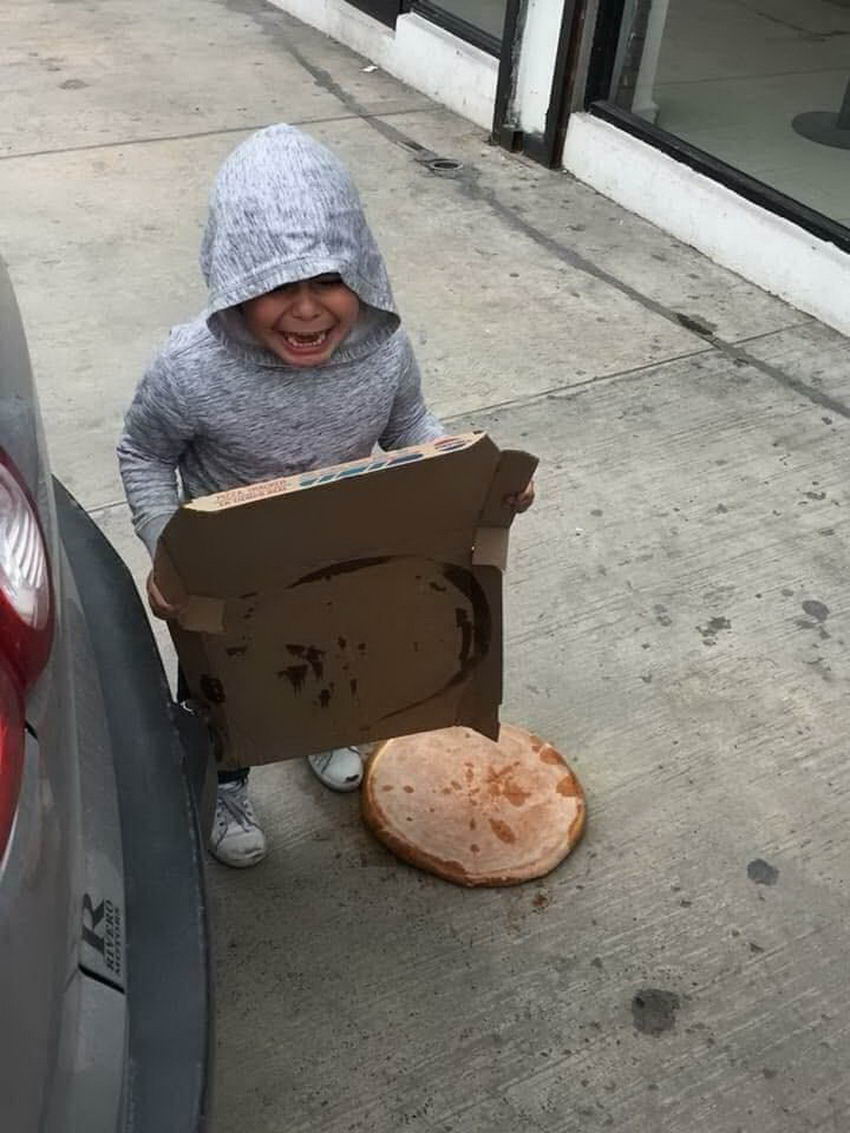 kid crying as his pizza is on the ground