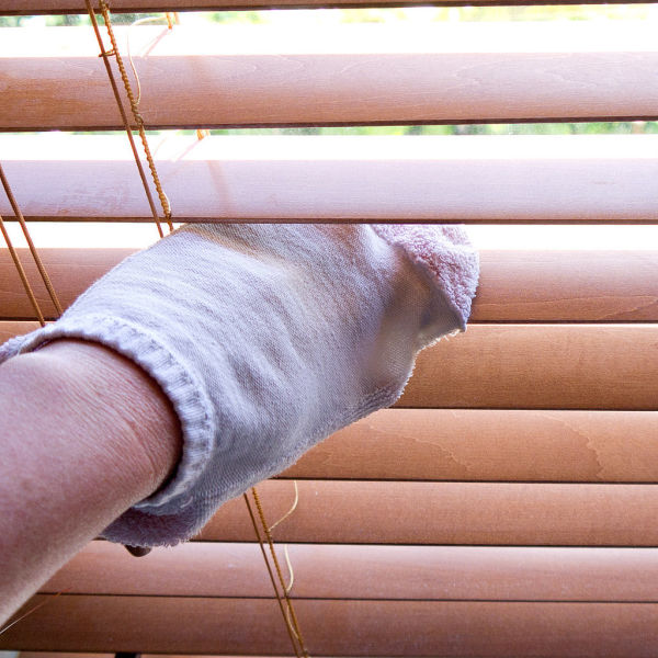 Sock Puppet Blind Cleaner - Put your hand in an old clean sock. Dip the sock in a bowl of equal parts water and white vinegar, then use it to wipe in between window blinds.