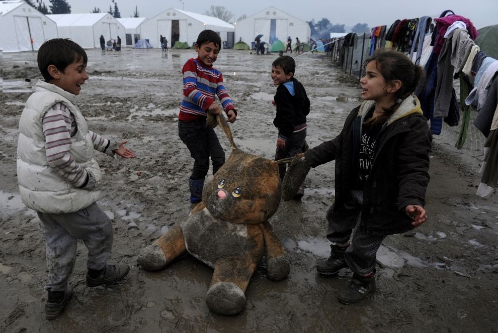Refugee children play at a makeshift camp by the Greek-Macedonian border near the Greek village of Idomeni