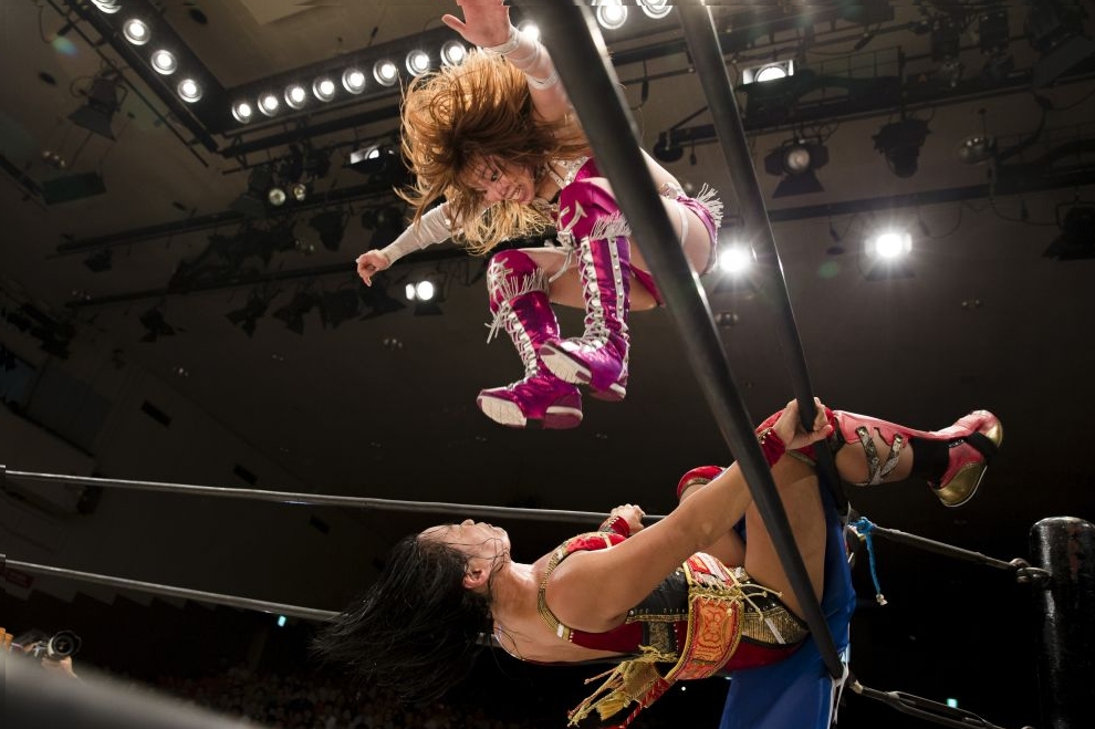 Wrestler Kairi Hojo jumps at her opponent Mieko satomura during their Stardom female professional wrestling show at Korakuen Hall in Tokyo, Japan, July 26, 2015.