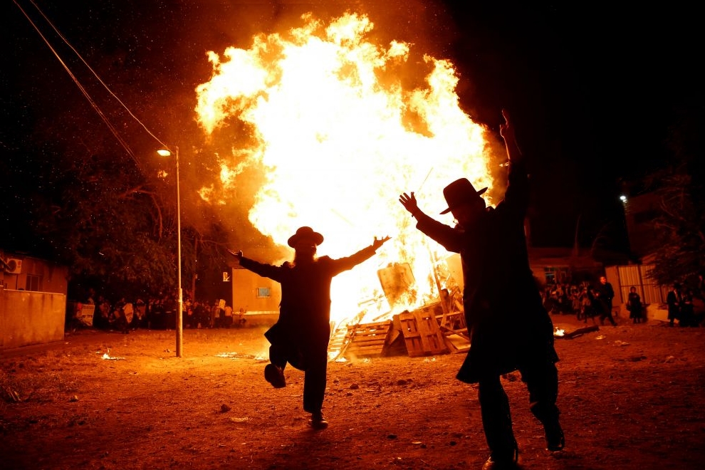 Ultra-Orthodox Jews dance next to a bonfire during celebrations for the Jewish holiday of Lag Ba-Omer in Jerusalem's Mea Shearim neighbourhood