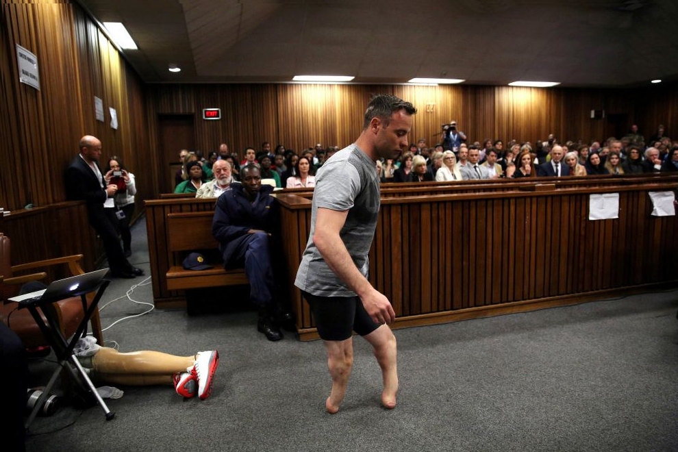 Paralympic gold medalist Oscar Pistorius walks across the courtroom without his prosthetic legs during the third day of the resentencing hearing for the 2013 murder of his girlfriend Reeva Steenkamp, at Pretoria High Court