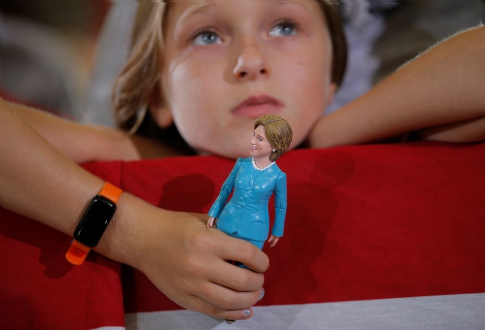 Nine-year-old Belle Shefrin holds a doll of U.S. Democratic presidential nominee Hillary Clinton while listening to Clinton speak at a campaign rally in Akron