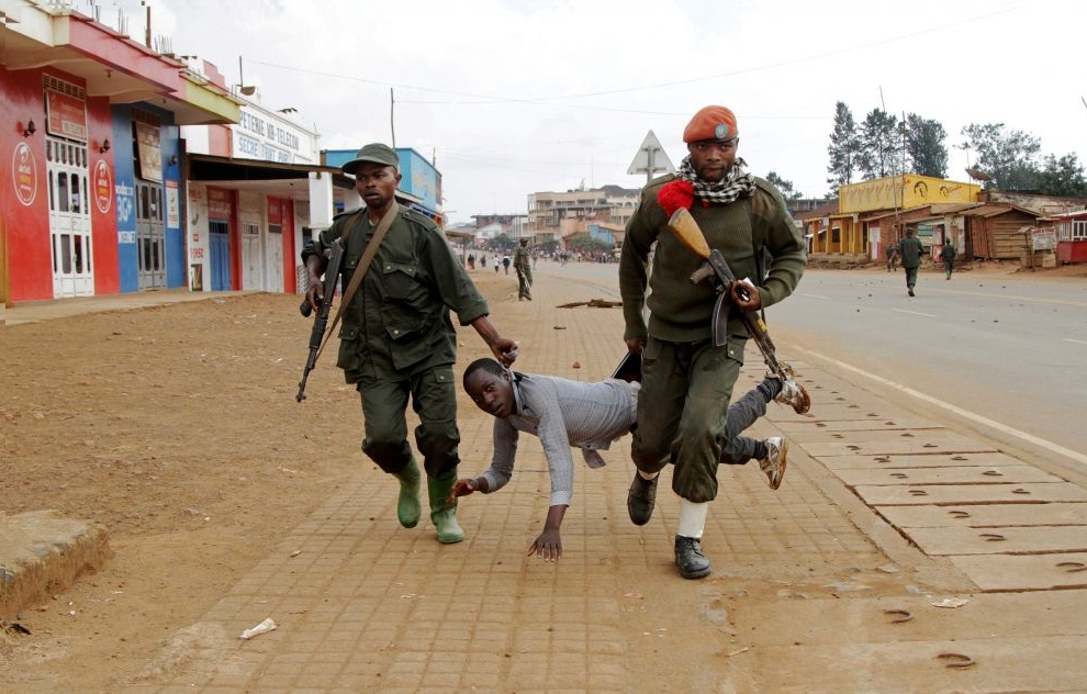Congolese soldiers arrest a civilian protesting against the government's failure to stop the killings and inter-ethnic tensions in the town of Butembo