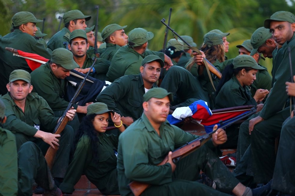 Cuban soldiers rest after participating in the celebration of the 60th anniversary of the Granma yacht in Playa Las Coloradas