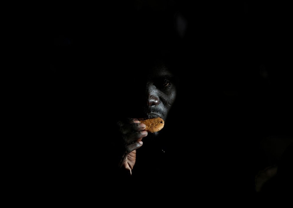 A migrant eats a biscuit on the Migrant Offshore Aid Station (MOAS) ship Topaz Responder after being rescued around 20 nautical miles off the coast of Libya, June 23, 2016.