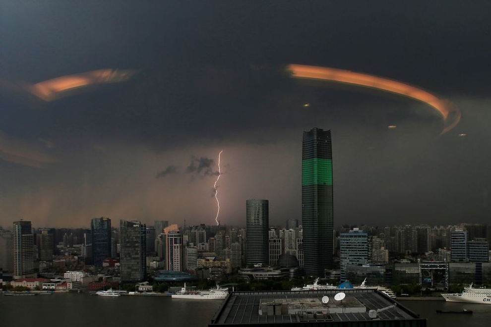 A streak of lightning is seen above the skyline of Shanghai