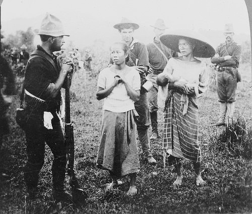 2 Terrified women are taken in for questioning South of Manila at the beginning of the Philippine-American War in 1899. After the US bought the Philippines from Spain for $20 million after defeating Spain in the Spanish-American War as part of their post war treaty, the local Filipinos immediately revolted, refusing yet another colonial rule. The US with now a firm territory in the Pacific never considered allowing the local population independence. The 3 year war was horrific. The US soldiers considered Filipinos nothing higher than a dog, and during operations, would routinely slaughter them. Men, women, children, it did not matter. During the war alone, around 20,000 Filipino soldiers died in the fighting, but the soldiers killed around 34,000 unarmed civilians as well. Another 200,000 civilians died due to an outbreak of Cholera, which the US did virtually nothing to contain or treat outside their own soldiers. The US lost around 6,000 killed as well. The atrocities were so bad that at least 6 known soldiers in 1900 alone defected to the Filipinos side. Those soldiers were Privates John Wagner, Edward Walpole, Harry Dennis and John Allance, a Private Meeks and Private William Hyer whom all became vital in organizing civilian resistance. Sadly, the war may have ended in 1902, but the killing continued through Guerilla warfare in the Moro Rebellion that lasted until 1913. Figures of Filipino dead from that conflict were also extremely high, but I could not find a good source with exact figures.
