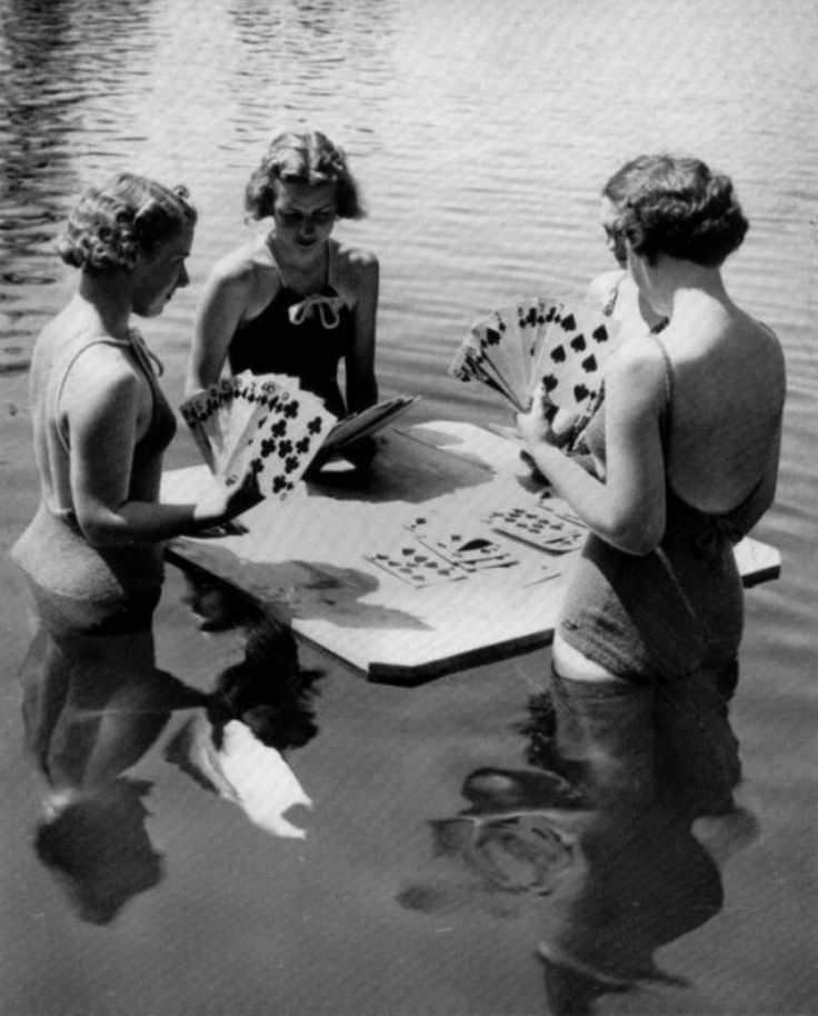 Women playing cards on a makeshift table at the beach somewhere in the US in 1922.