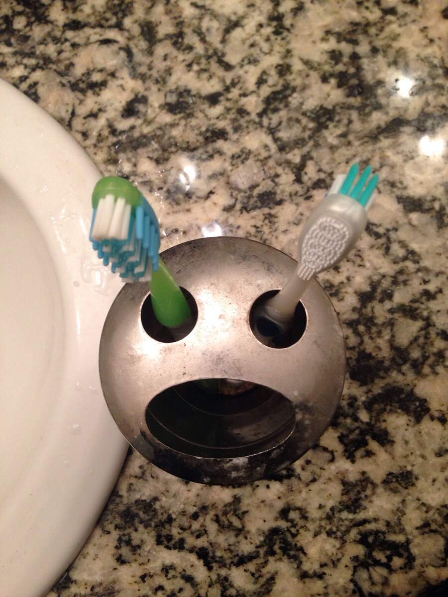 This toothbrush holder looks like a man getting his eyes gouged