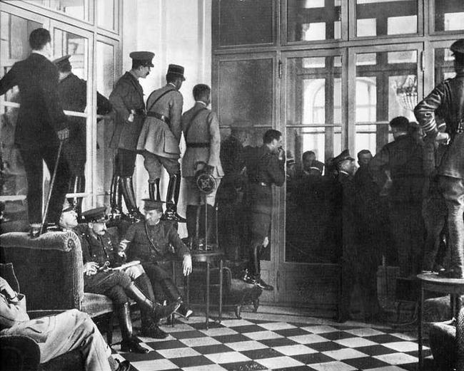 1919 - Spectators watch the signing of the Treaty of Versailles.