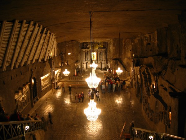 973 Years Old  The Wieliczka Salt Mine, Poland. The Wieliczka Salt Mine, located in the town of Wieliczka in southern Poland, lies within the Krakw metropolitan area. The mine continuously produced table salt from the 13th century until 2007 as one of the worlds oldest operating salt mines the oldest being the Bochnia Salt Mine. It is believed to be the worlds 14th-oldest company still in operation. The mines attractions for tourists include dozens of statues and an entire chapel that has been carved out of the rock salt by the miners. About 1.2 million people visit the Wieliczka Salt Mine annually. Commercial mining was discontinued in 1996 due to low salt prices and mine flooding.