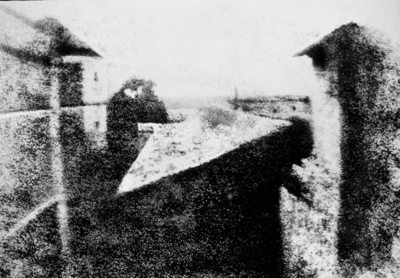 Taken by Nicphore Nipce, this is the first photograph ever taken which still exists. He called his method heliography sun writing and this photograph took 8 hours of exposure time hence sunlight on both sides of the building.