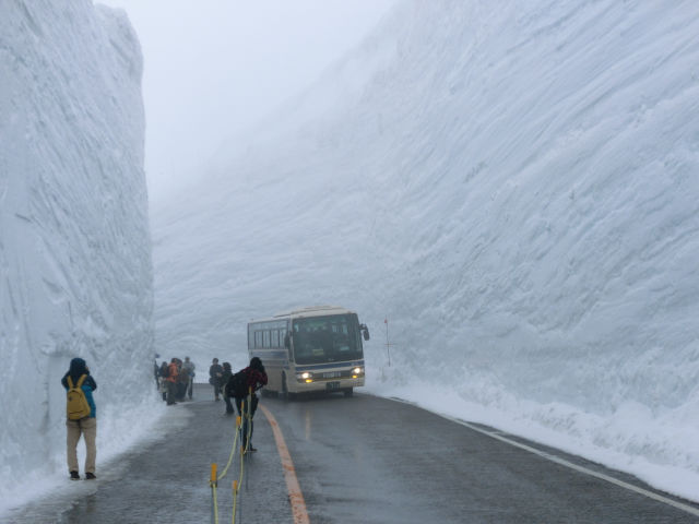 Cleared road in Japan surrounded by 60 ft snow walls