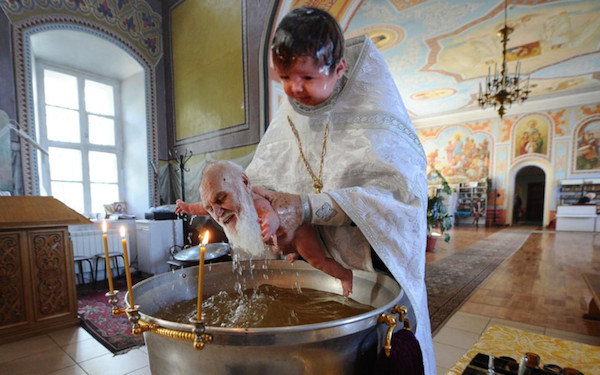 priest baptizing baby - Su