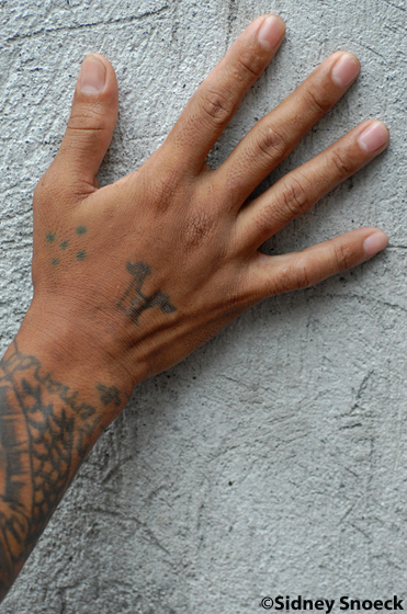 The Five Dots - This is different from the three dots tattoo in that it is representing the time spent in prison. The four dots on the outside represents the four walls and the one in the middle represents the inmate.