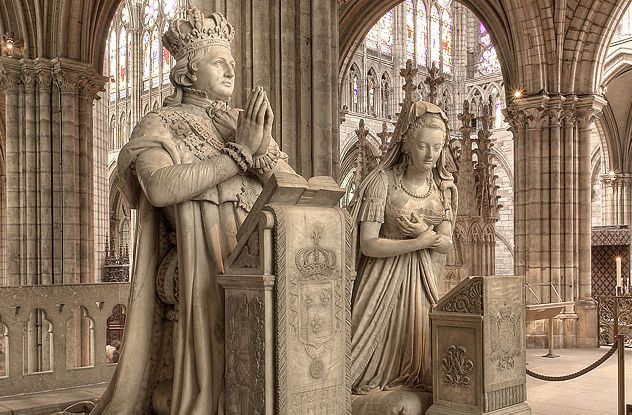 Government-Sponsored Desecration: 
During the French Revolution, a decree was made that the tombs of the kings and queens of France should be destroyed, particularly those at the Basilica of Saint Denis. On October 12, 1793, a mob intent on destruction descended on it and other church grounds. One of the first coffins they came upon, though, was Henry IV’s. Henry had been a popular king, and they treated his remains with a kind of curiosity, if not awe. The body was in pristine condition after its embalmment. Even the stab wounds from where he had been assassinated were still visible. The fascinated crowd set the corpse on display, and it became an attraction to thousands who flocked to see the late monarch. It seemed for a time that the desecration operation would be canceled for lack of popular demand. Not everyone was impressed by Henry, though. One republican guard cut off the king’s mustache and put it on his own face. Another cut off the beard for a souvenir. After a short speech by another of Henry’s audience, who sarcastically remarked the crowd should put him on the altar if they loved him so much—maybe he’d do a miracle—Henry was thrown into a common grave pit. The desecration resumed. Some of the corpses were very old bodies tightly sealed within tombs. There were health hazards. The odor that some of the bodies exuded was so terrible that they boiled vinegar to cover the smell. Several people even caught diseases and died before they finished wiping out the remnants of the old worthies.