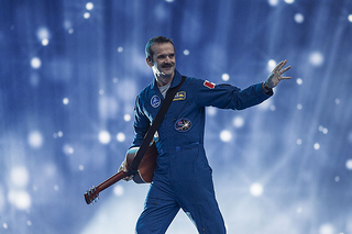 Space Oddity isn’t the only space themed song he knows.
Hadfield created the first ever music video in space with his rendition of David Bowie’s song Space Oddity. Chris had his son Evan re-write the lyrics about the astronaut dying. What you may not know is years ago Chris also learned the song, Rocket Man by Elton John. He did so in hopes of one day meeting Elton for a jam session. They met. No song. We need to fix this! Until then, enjoy his cover of Space Oddity.