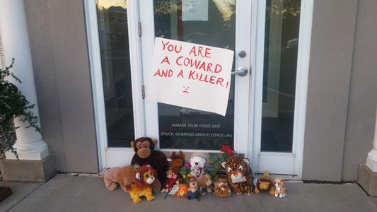A memorial to Cecil the lion outside Dr. Walter J. Palmer's closed dental office in Bloomington, Minn.