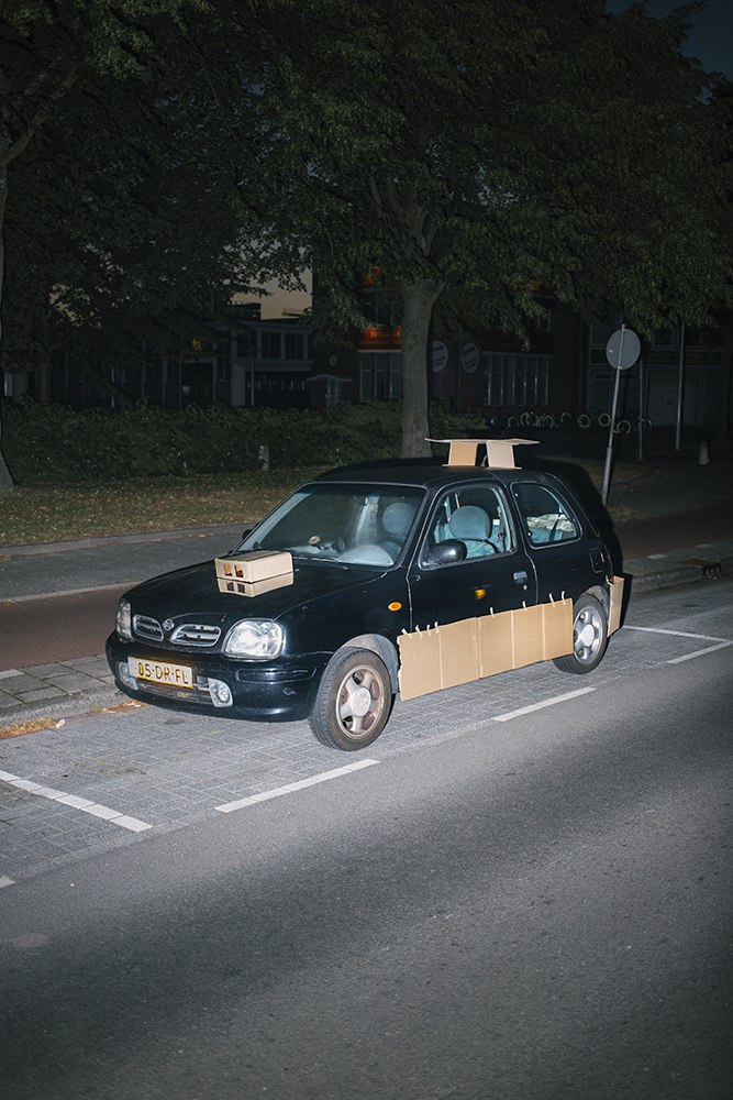 This Guy Walks The Streets At Night Pimping Strangers’ Rides… With Cardboard