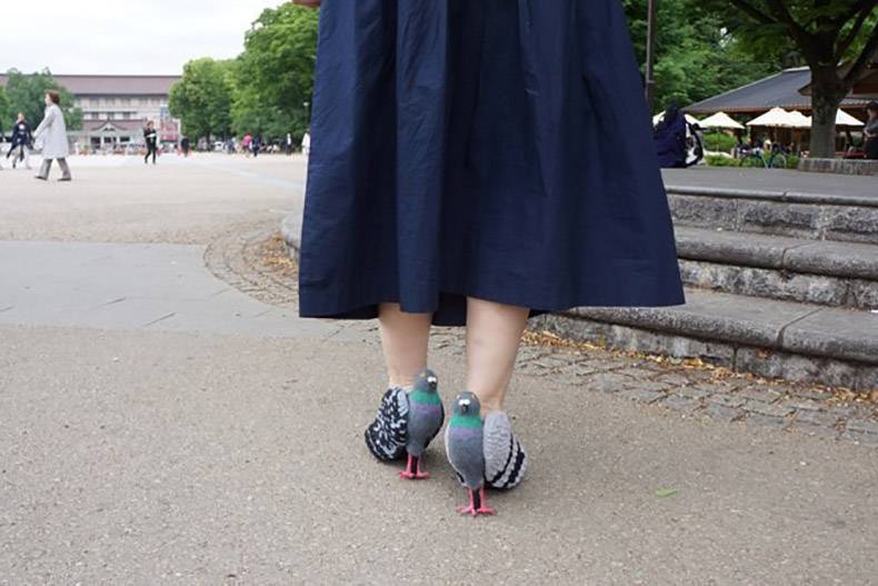Woman wearing heels that look like pigeons.
