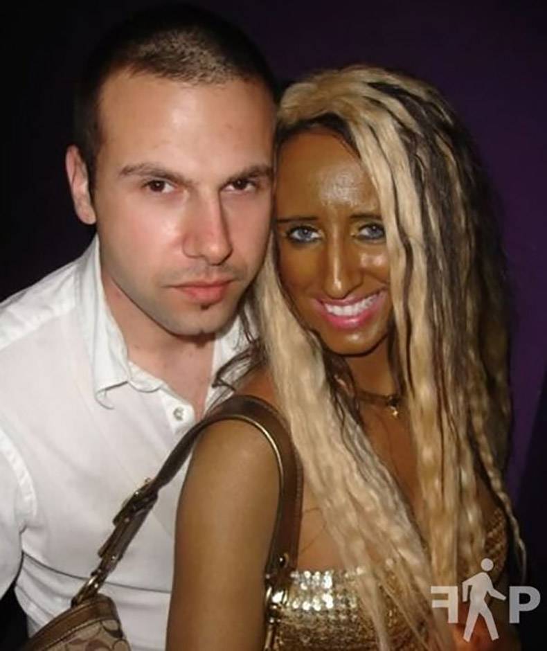 Girl who is way too tanned posing with normal white dude.